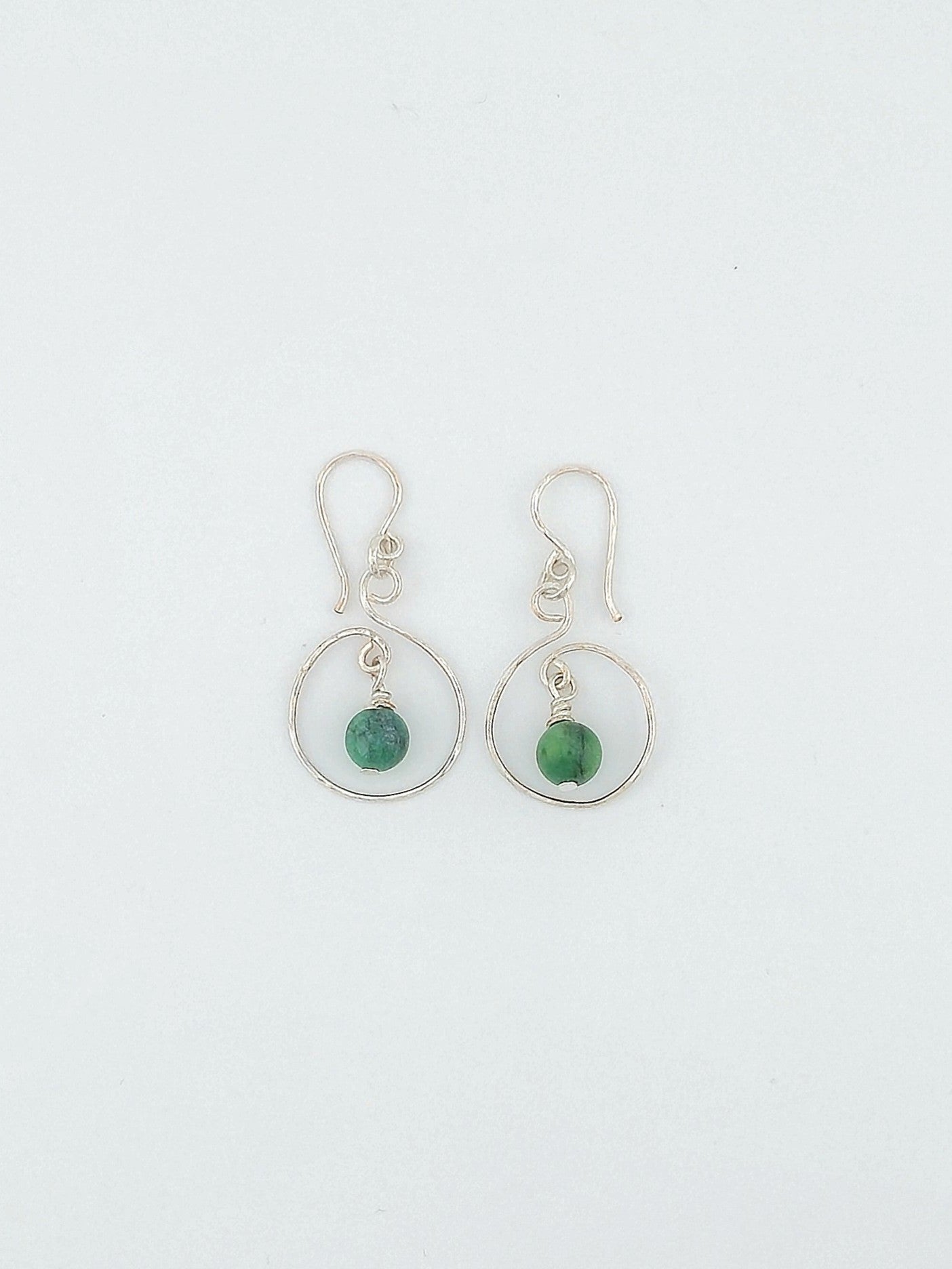 Handcrafted silver open swirl earrings with green tourmaline gemstone drops by Willow Tree Studio.